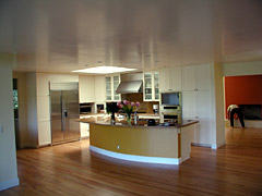 A kitchen with an island and stainless steel appliances.